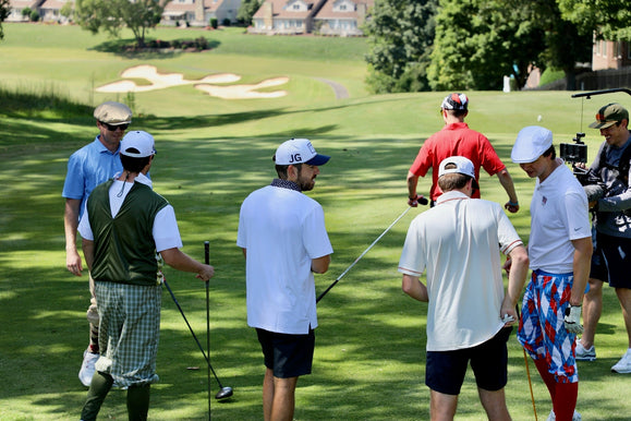 golfers preparing for their shot.