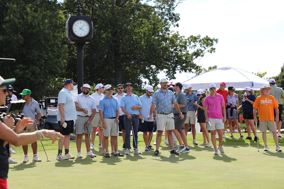 Golfers around the green preparing short game shots together