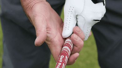 golfer adjusting grip before a shot
