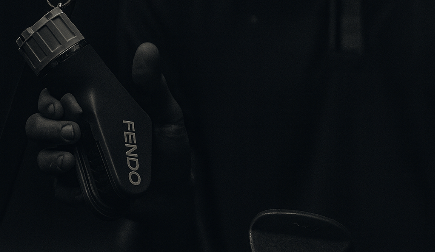 Hand holding a Fendo with dark overlay